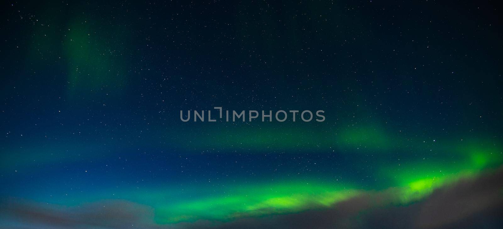 Northern Lights also known as aurora, borealis or polar lights at cold night over deep black star sky. Beautiful night photo of magic nature phenomenon. High quality photo