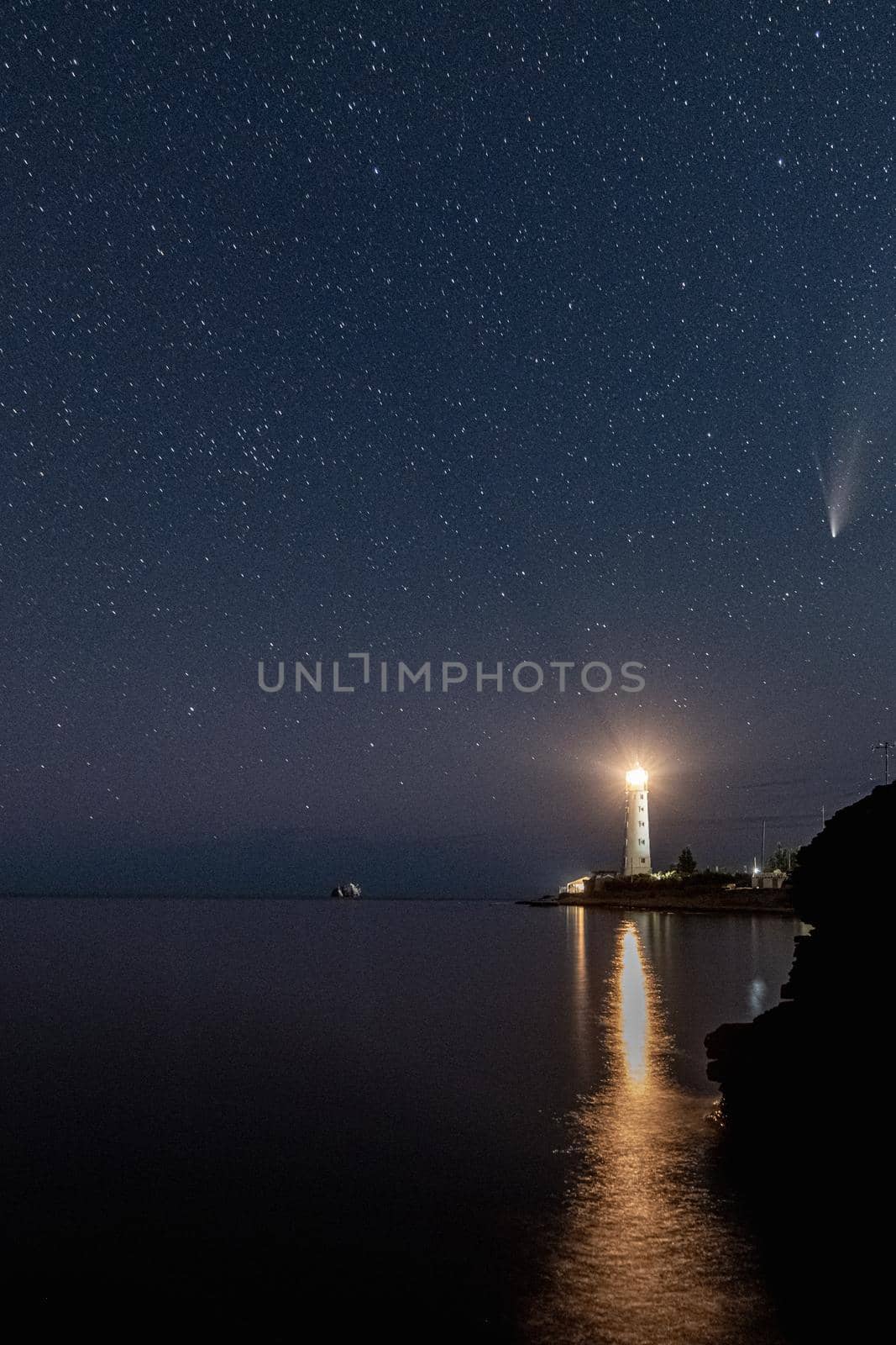 Panoramic HDR Landscape view of Neowise comet over white Lighthouse at night sky by MKolesnikov