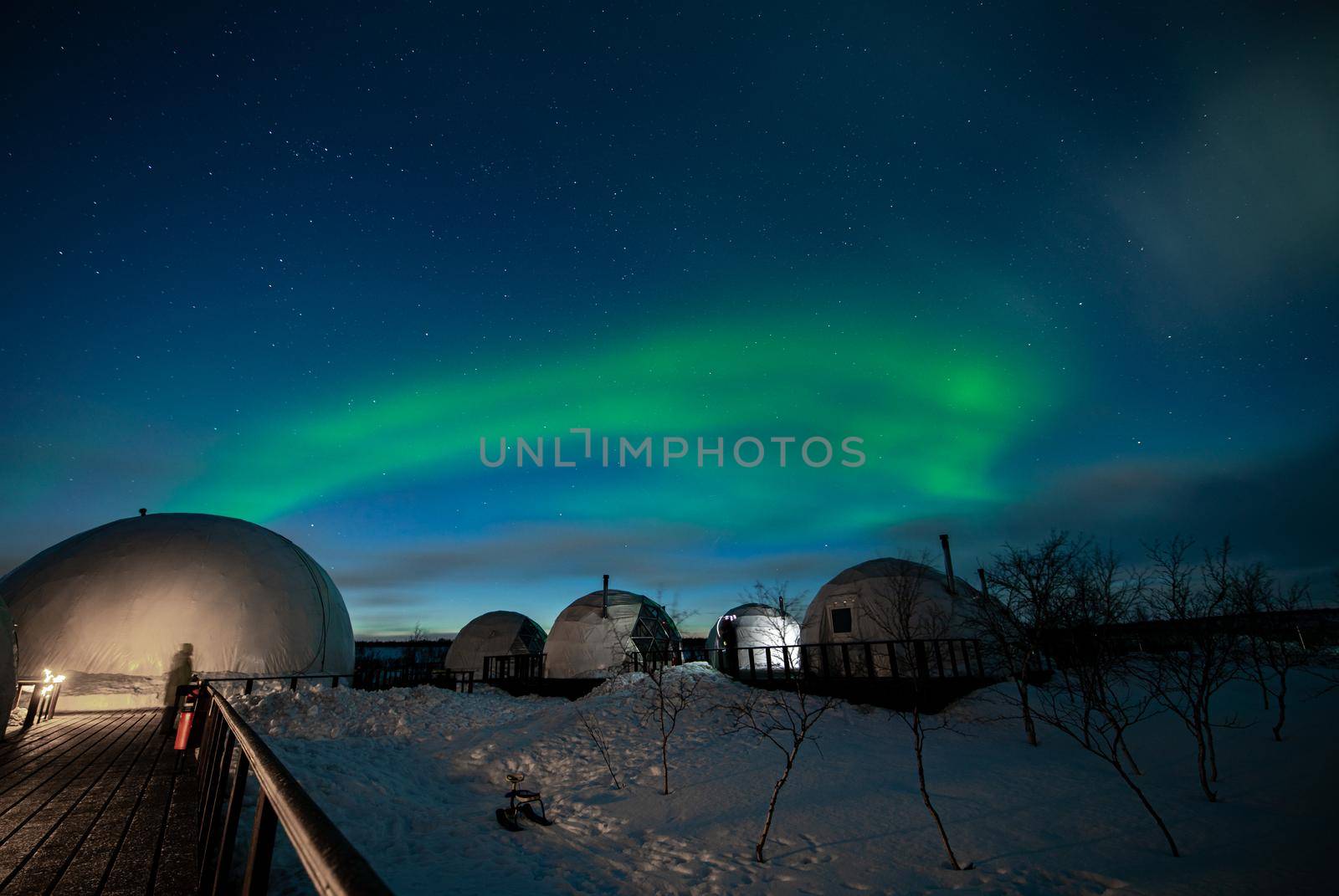 Northern Lights also known as aurora, borealis or polar lights at cold night over igloo village. Beautiful night photo of magic nature of winter landscape by MKolesnikov