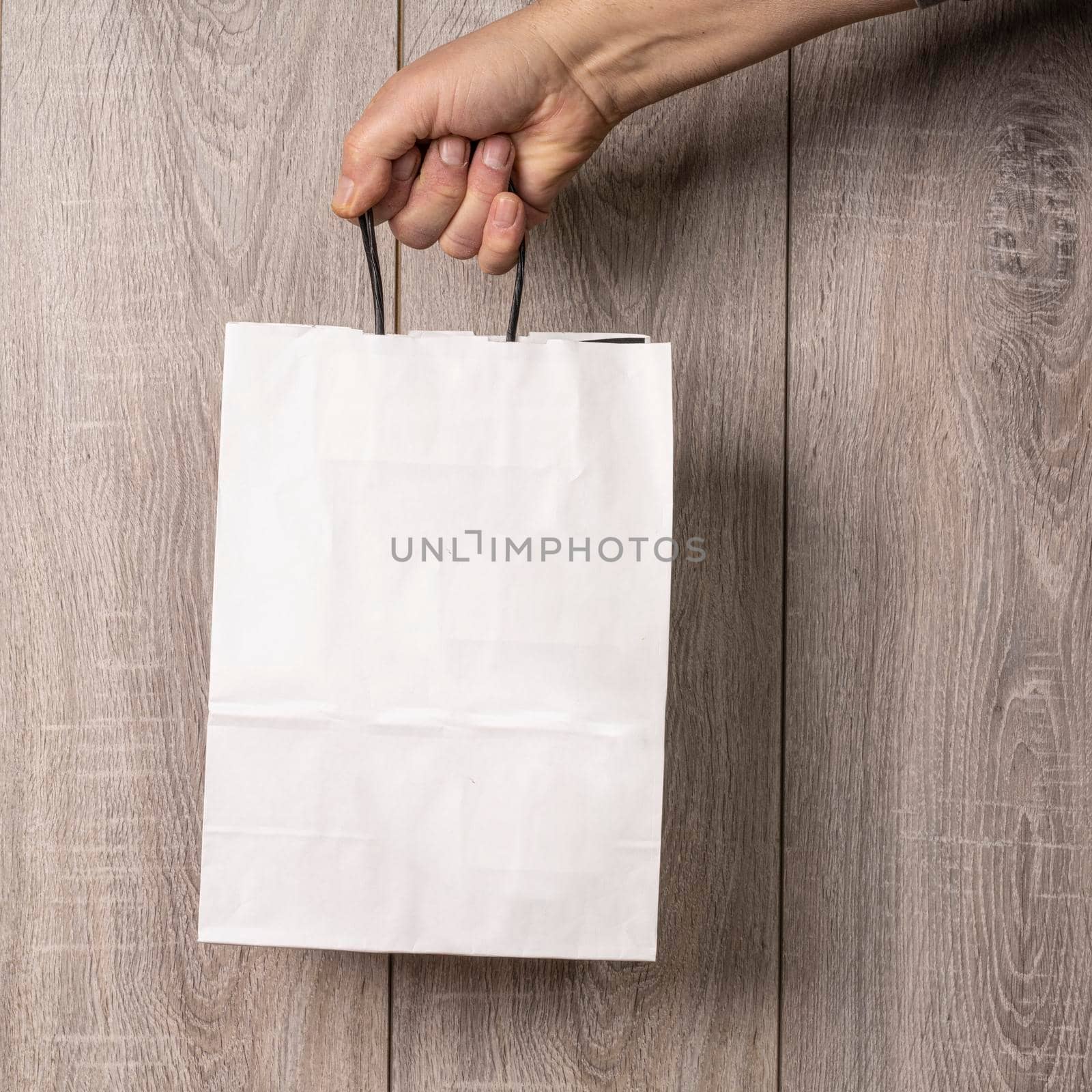 a reusable and recyclable paper bag in hand