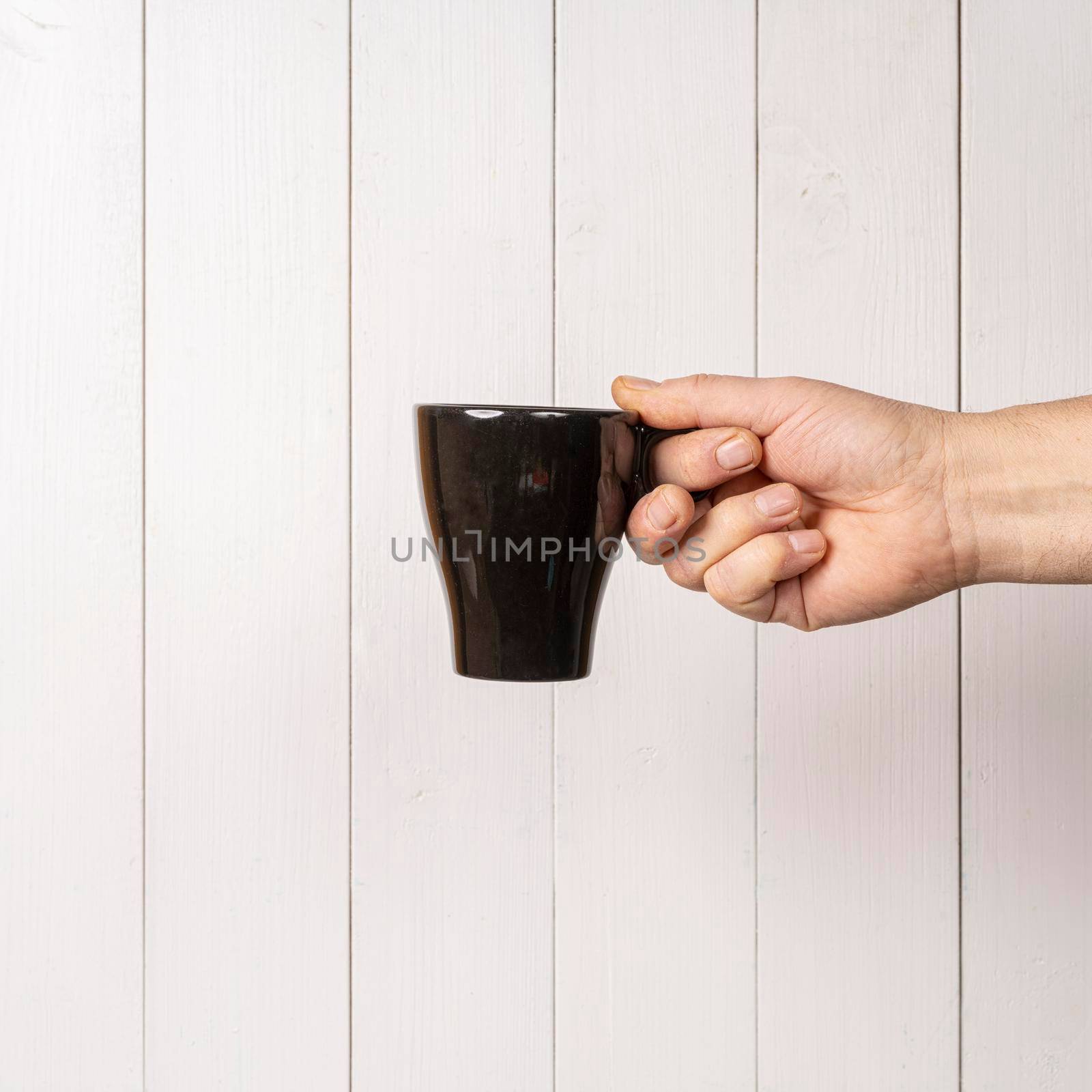 a cup of coffee in hand