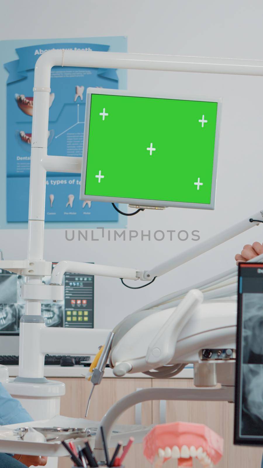 Dentist and assistant looking at green screen on monitor by DCStudio