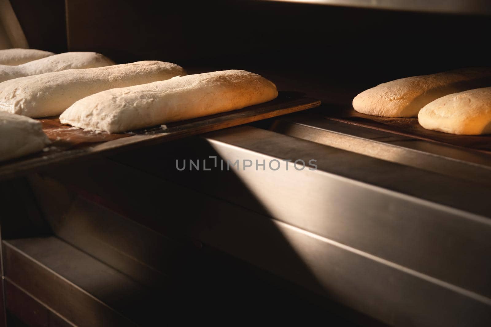Close-up Batch of fresh buns of artisan bread baked in an oven in cooking and eating concept.