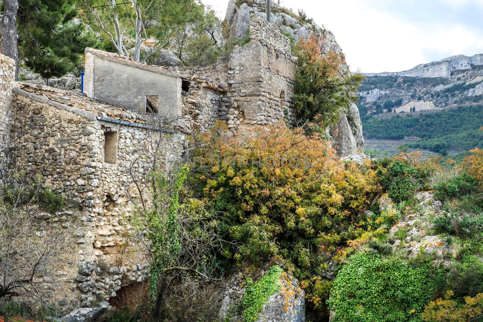 Beautiful view of Guadalest village surrounded by vegetation, mountains and the walls of the Castle