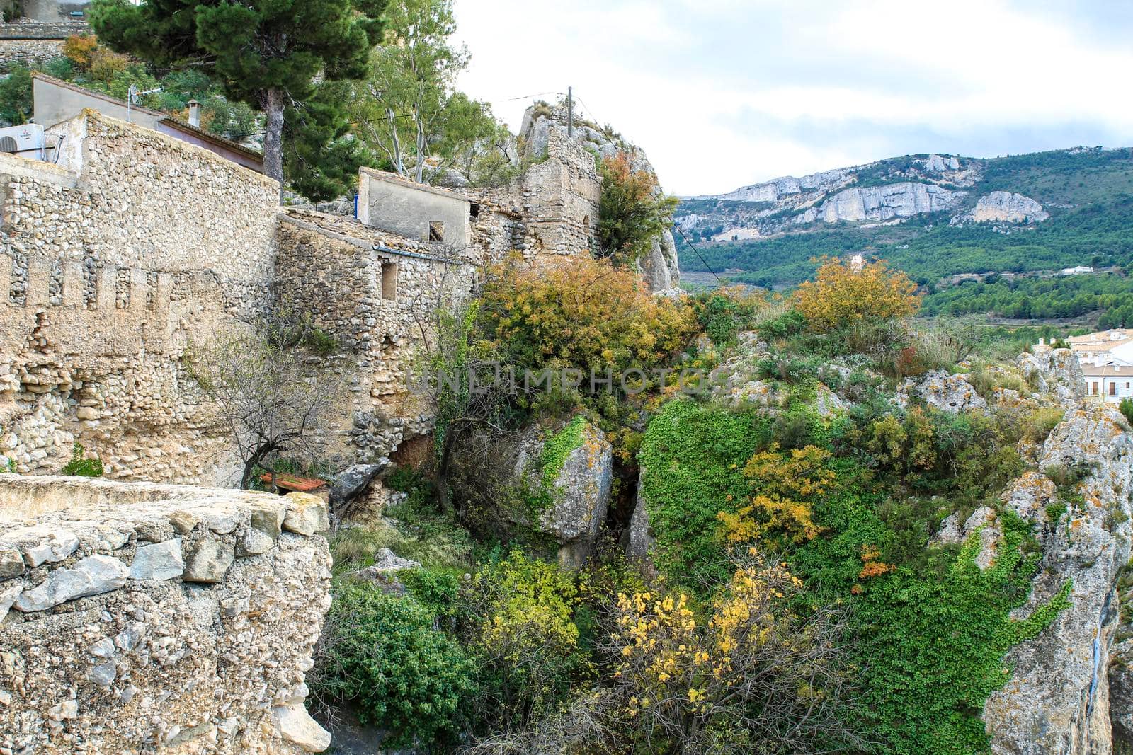 Beautiful view of Guadalest village surrounded by vegetation, mountains and the walls of the Castle
