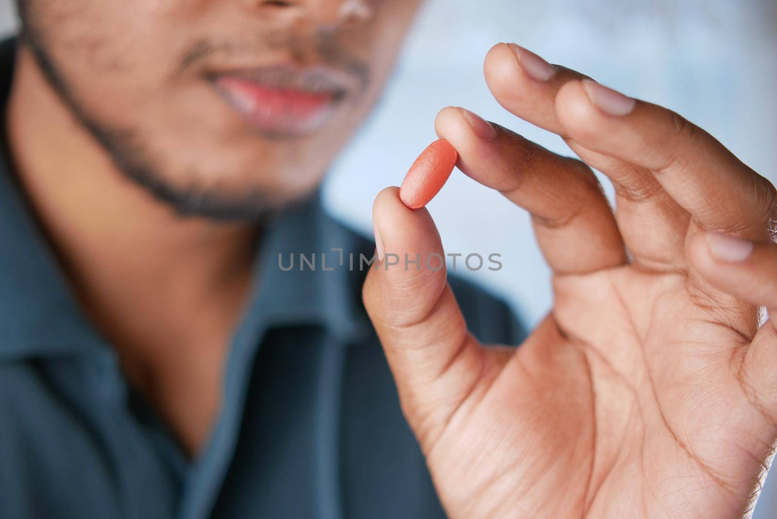 upset man hand holding medical pills .