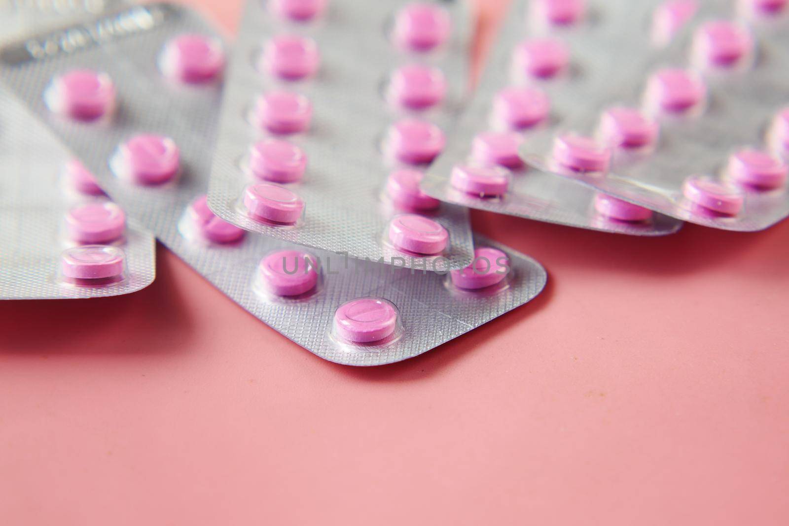 Close up of pills of blister pack on table .