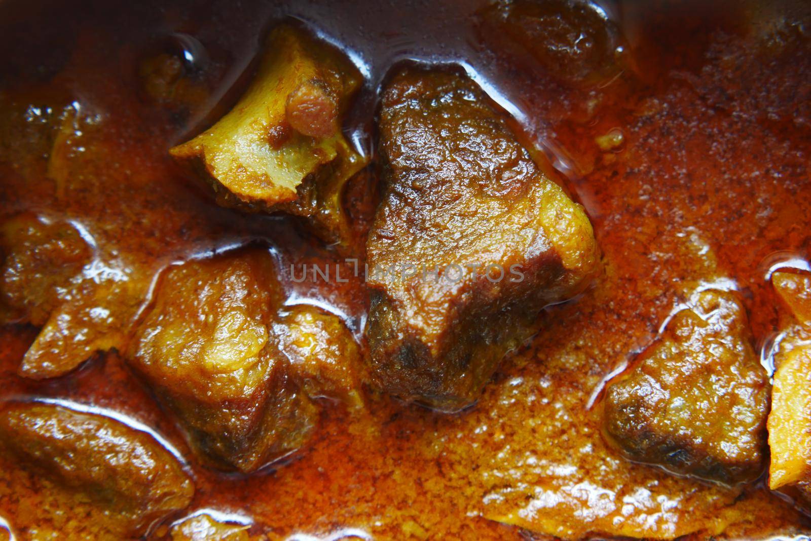 traditional Indian curry lamb masala in a bowl on table.