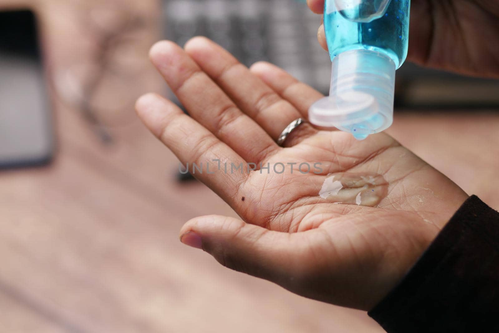 close up of young man hand using sanitizer gel for preventing virus.