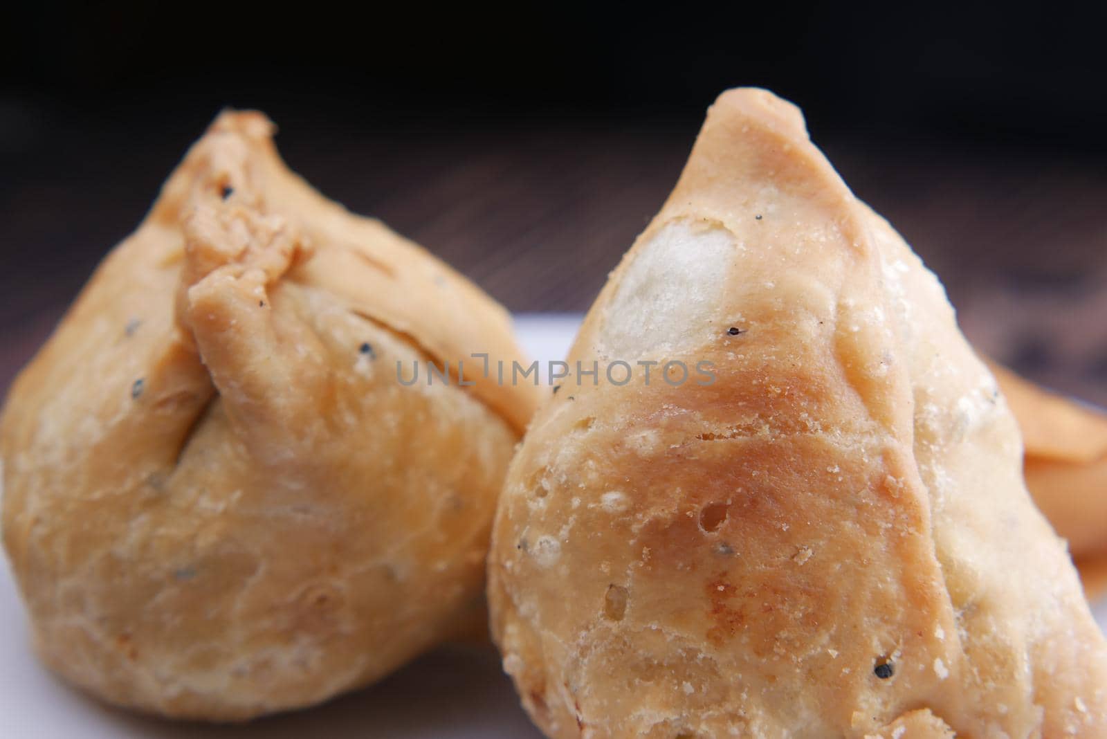 detail shot of a indian food singara on plate .