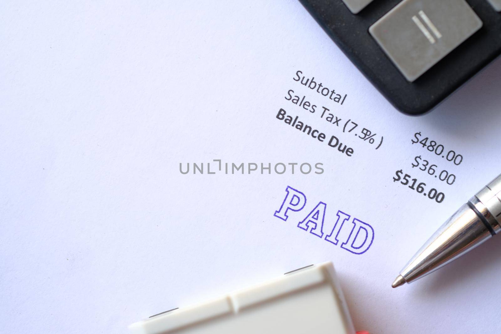 Paid invoice and Rubber Stamp on paper