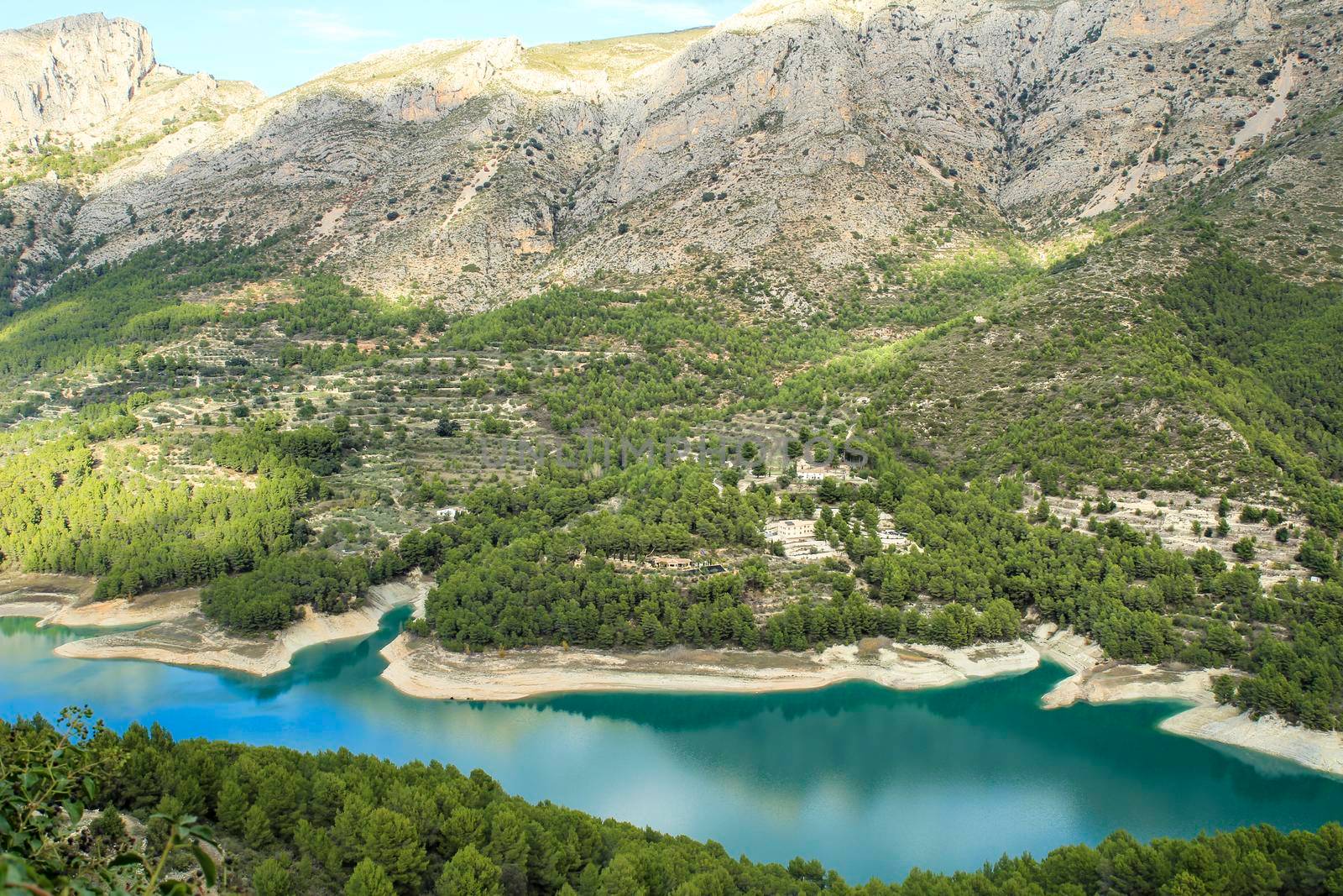 The swamp of Guadalest village surrounded by vegetation and mountains on a sunny day