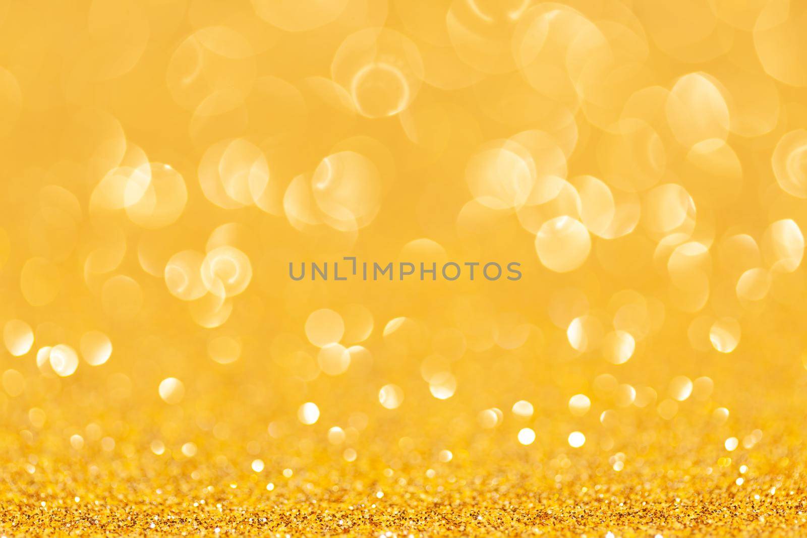 sparkles of yellow glitter abstract background. Copy space.