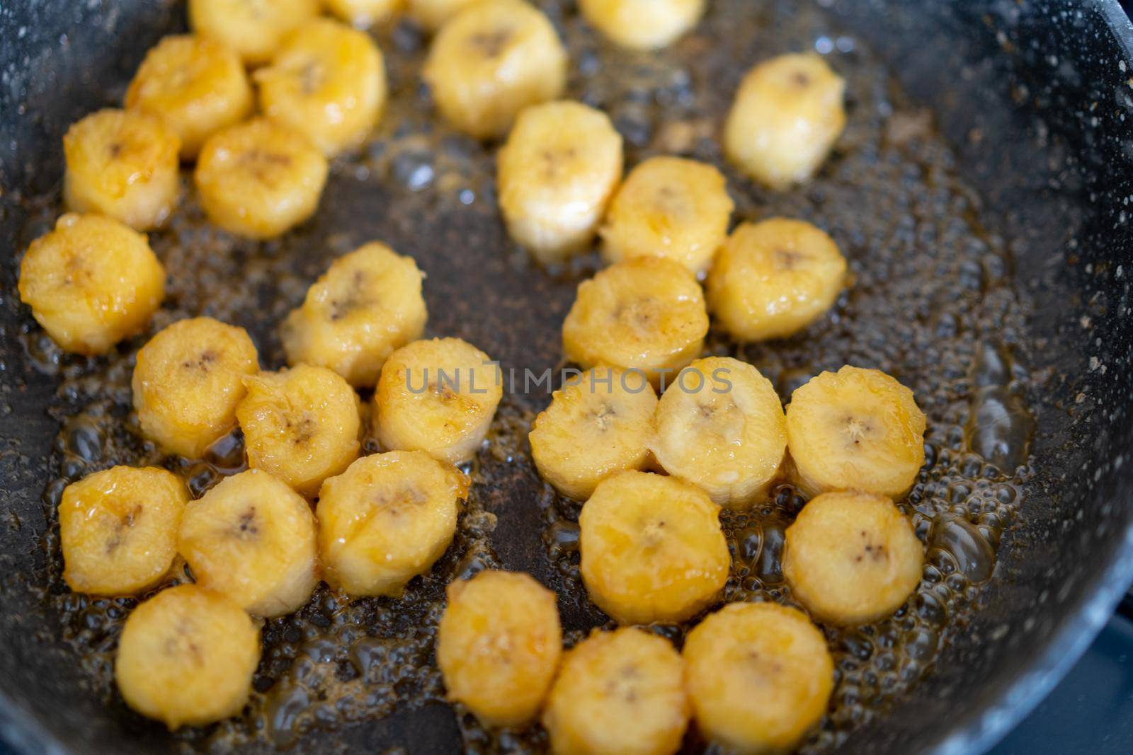 Process of cooking caramelized banana in a frying pan at home Selective focus Healthy