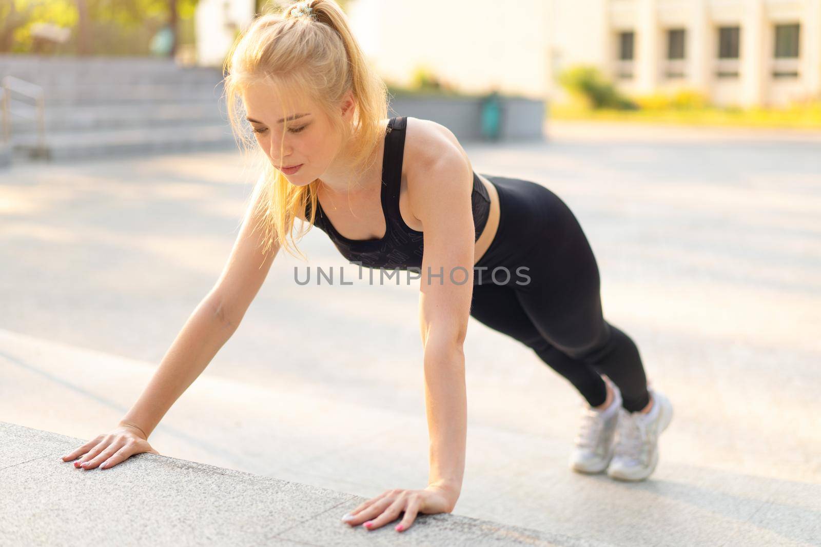 Sport and Fitness Fit Young Adult Woman Doing Plank Exercise Outdoor Urban Environment. Sunlight Summer Park Caucasian Ahlrtic Female Morning Workout Training Exercises Endurance Abs Muscle