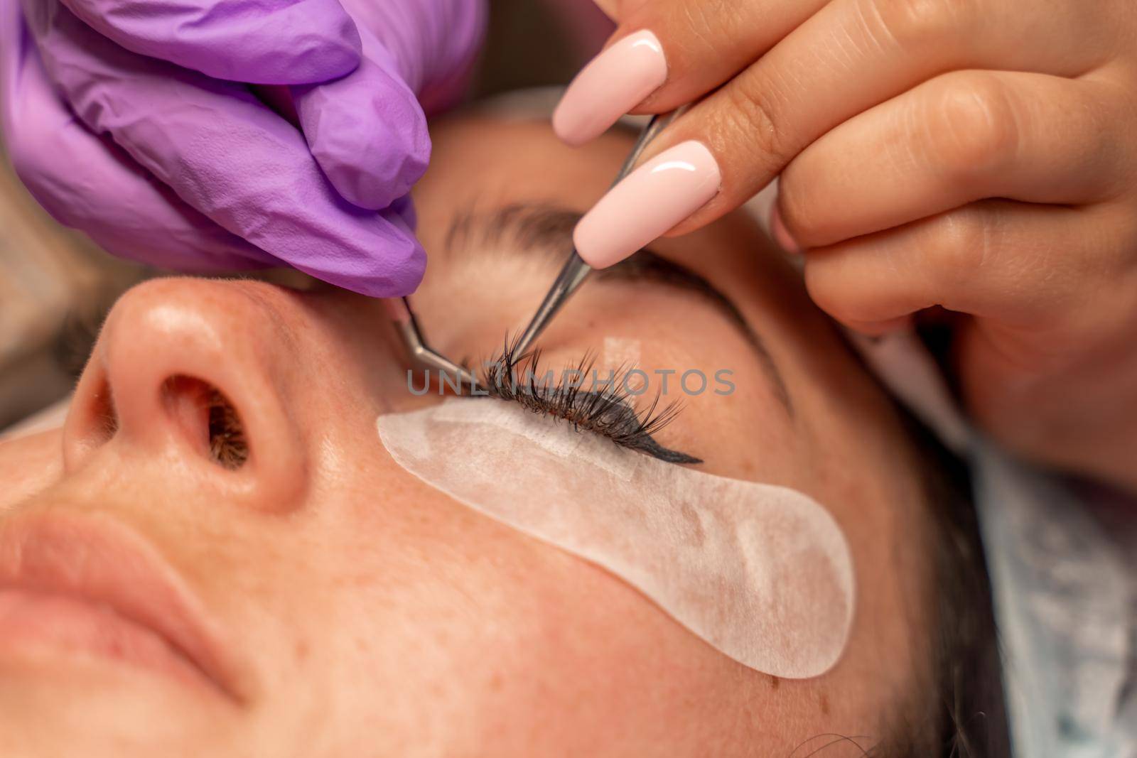 Eyelash extension procedure. Woman eye with long eyelashes. lashes, close up, macro, selective focus