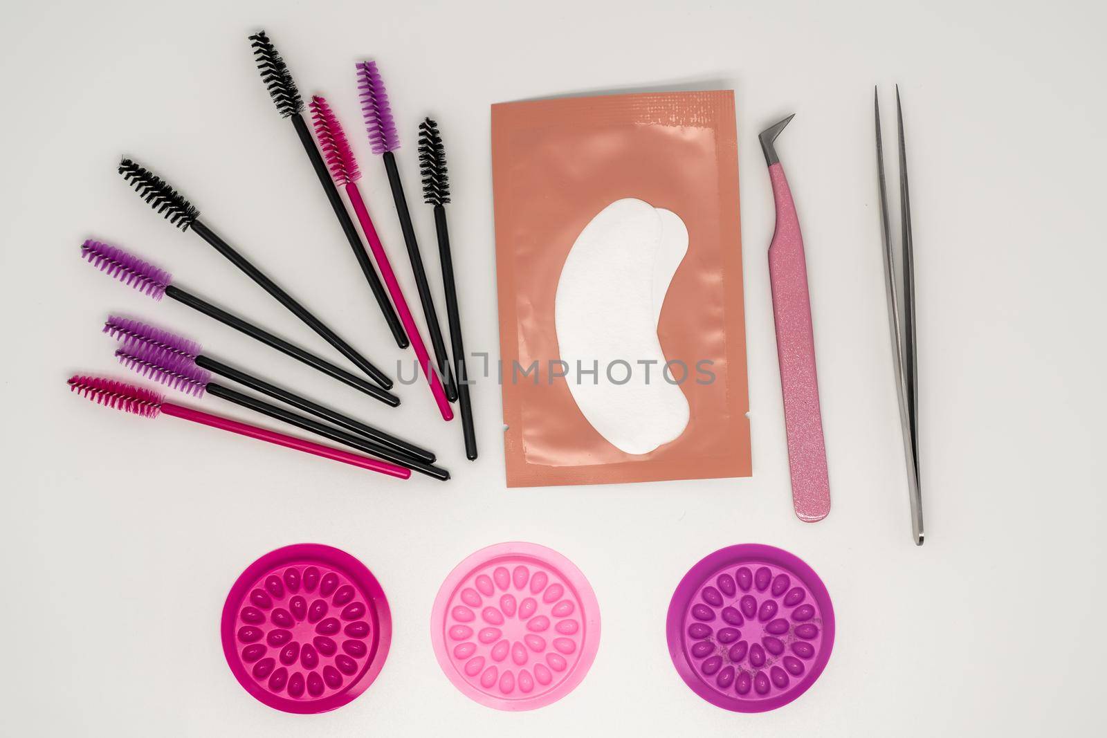 Eyelash extension tools, eyelash combs and eyelashes on a white background