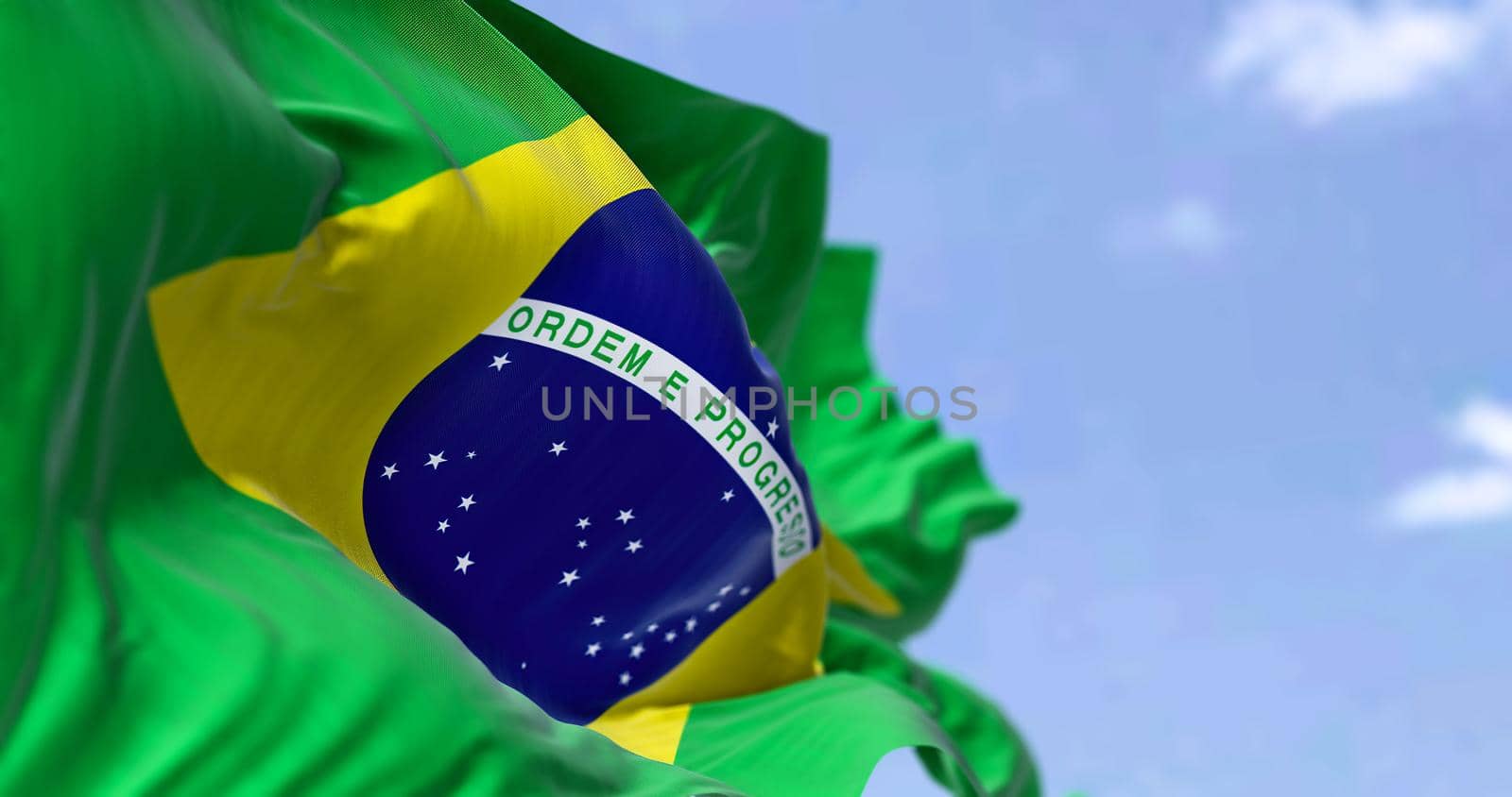 Detailed close up of the national flag of Brazil waving in the wind on a clear day. Democracy and politics. South american country. Selective focus.