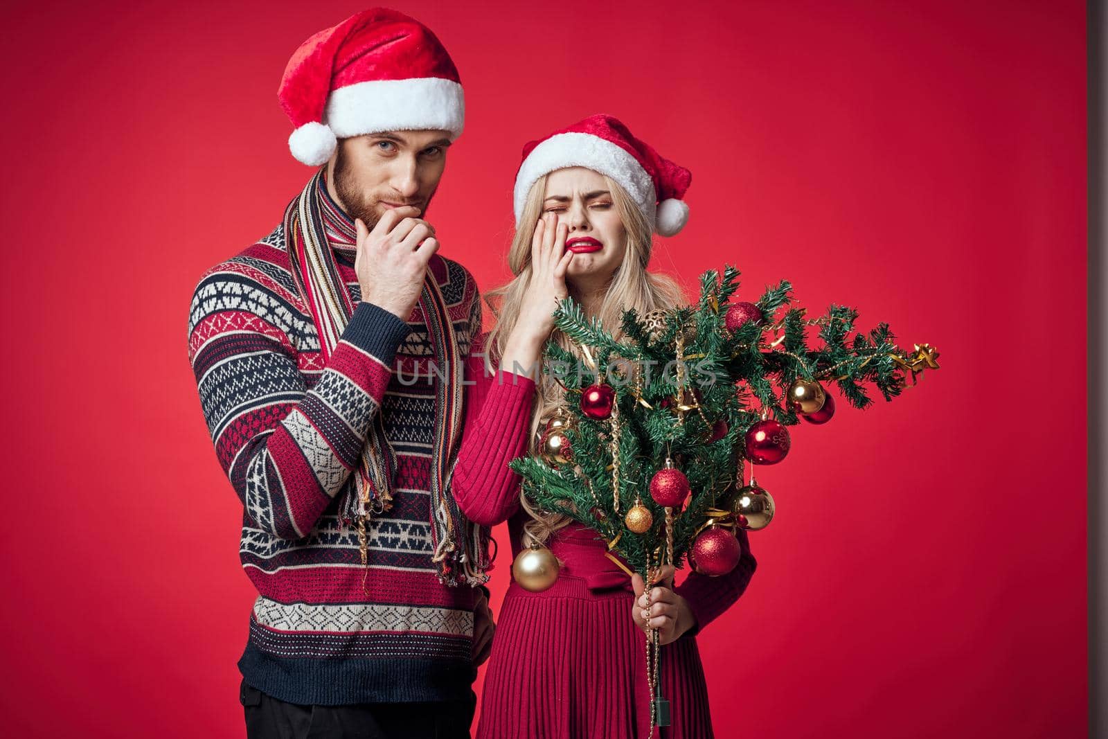 emotional young couple celebrating christmas decoration together. High quality photo