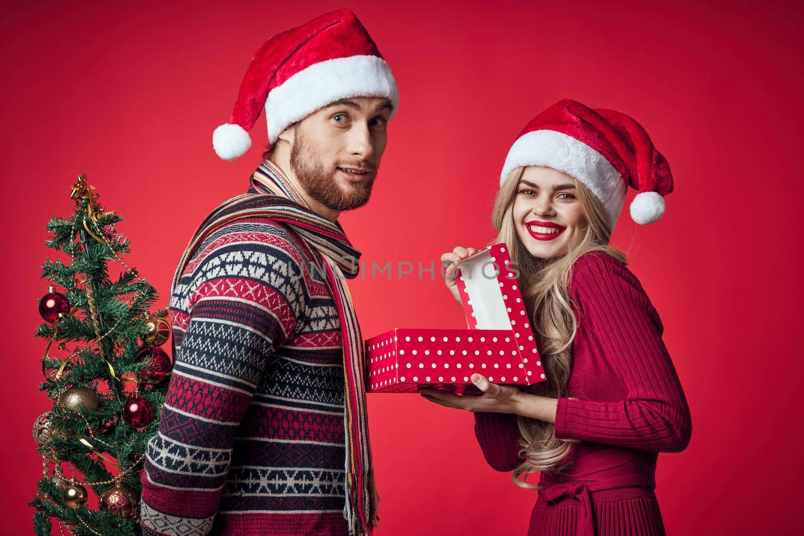 emotional man and woman gifts christmas new year red background by SHOTPRIME
