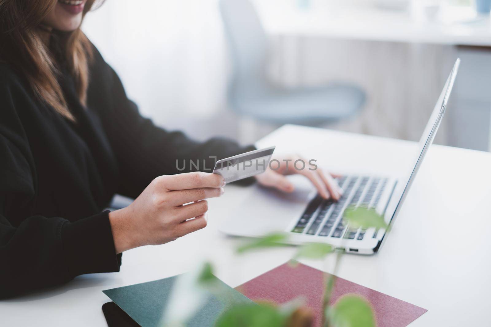Woman enjoy with online shopping application and typing credit card for fill number to payment with virtual digital asset and metaverse icon on screen. by itchaznong