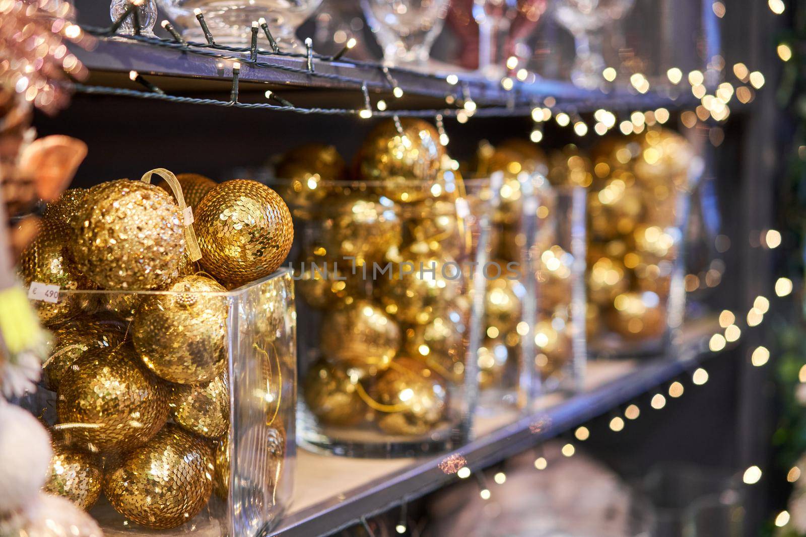golden balls. Market of decor . Lots of christmas decoration in store. Christmas shopping for new year tree. by Malkovkosta