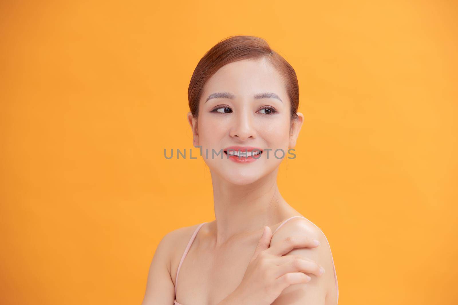 Woman with beauty face touching healthy facial skin portrait.