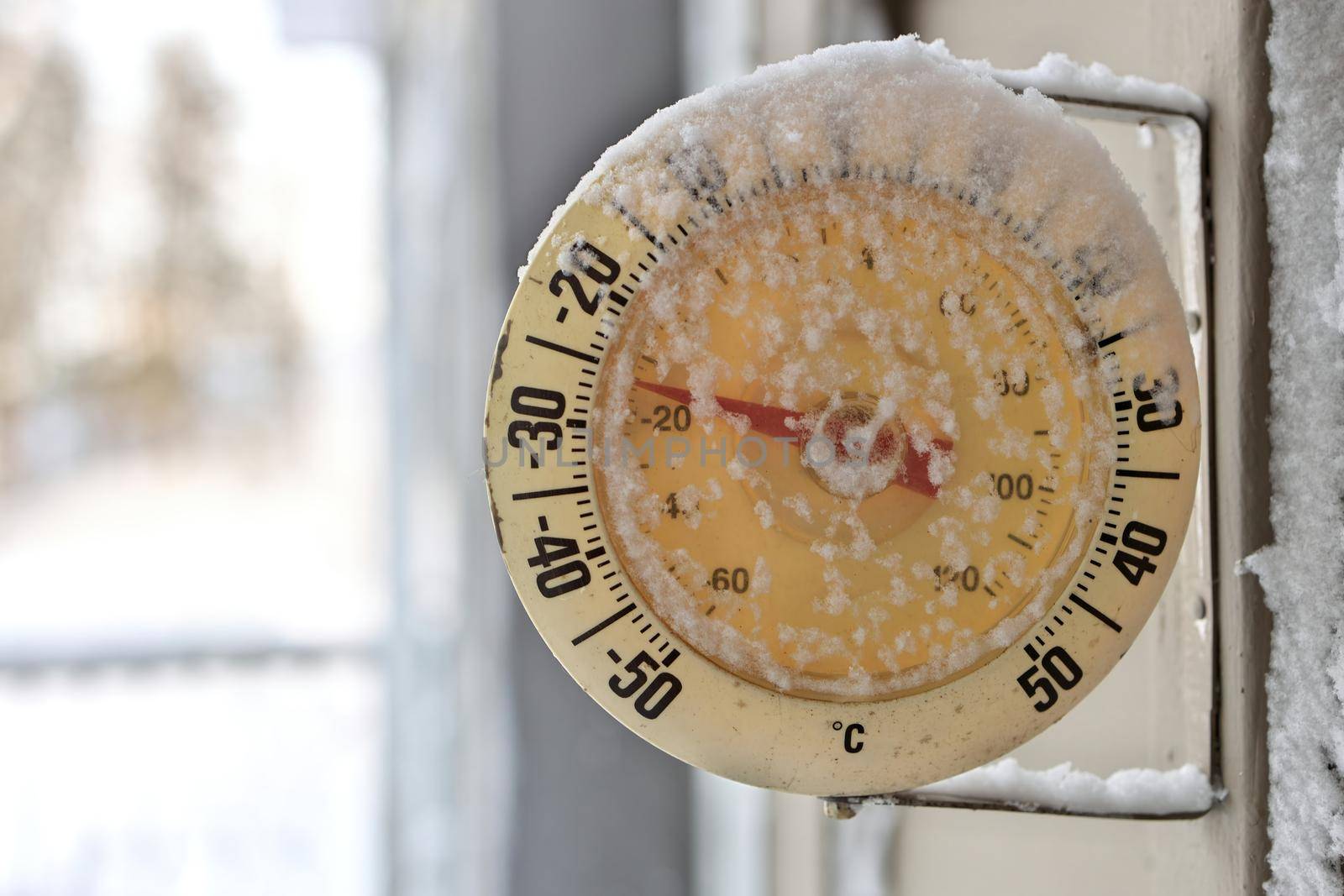 Frosty snow-capped outdoor Thermometer on a extremely cold, frigid winter's day by markvandam