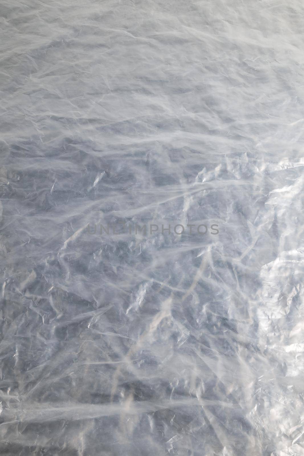 full frame background of flat crumpled semi-transparent polyethylene film.