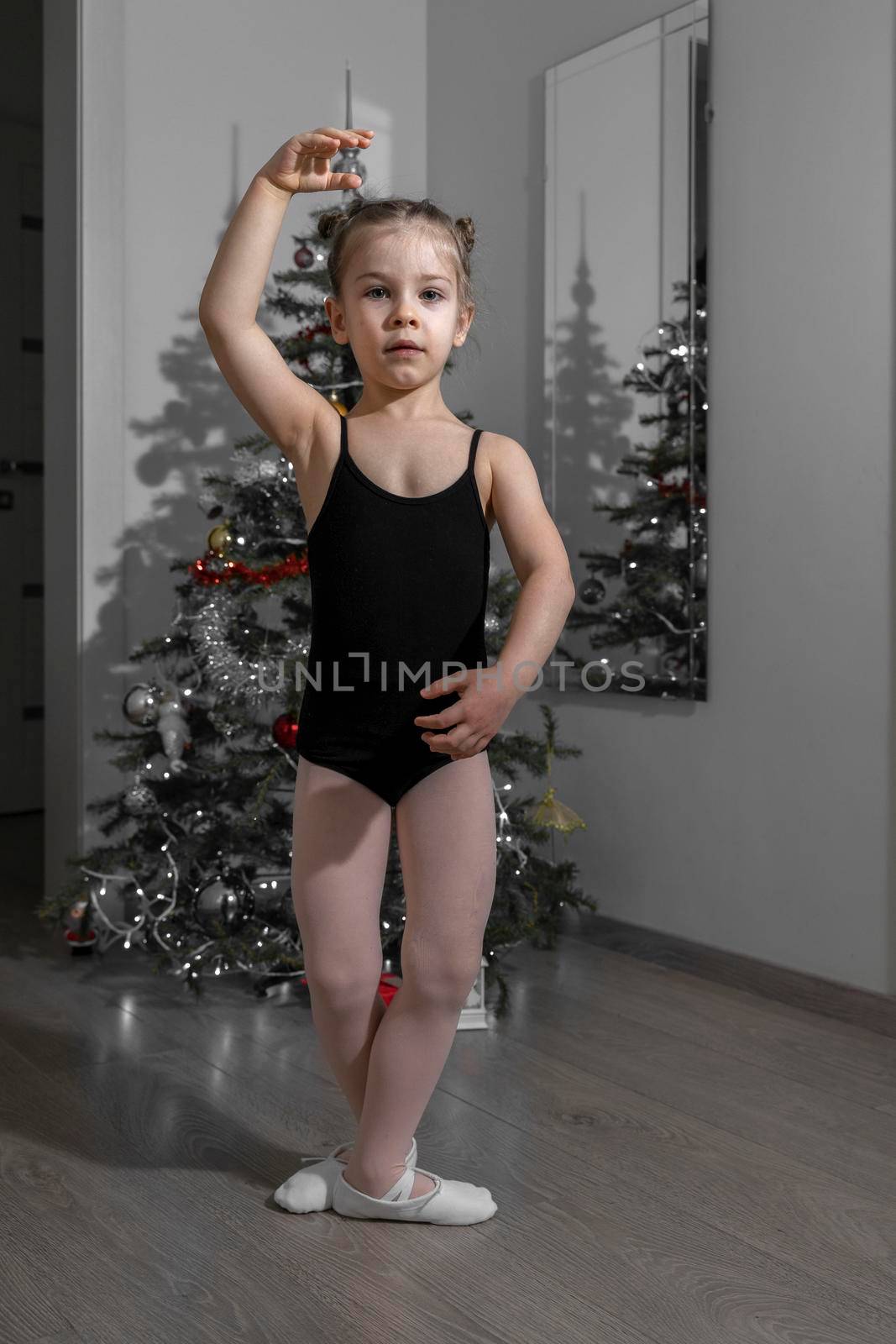 5-year-old girl dancing on Christmas evening by the tree