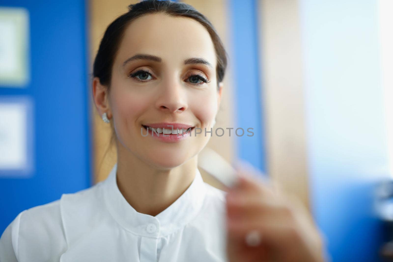 Portrait of beautiful office worker female touch virtual screen with silver pen. Make corrections on modern virtual device. Business, development concept