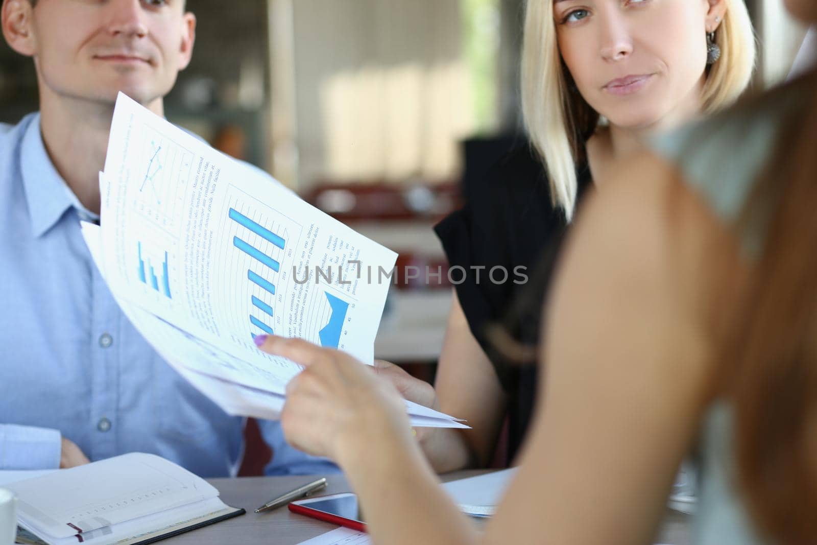 Close-up of business partners discuss report or contract in company office, businesspeople listen to employee. Business, career, strategy, deal concept