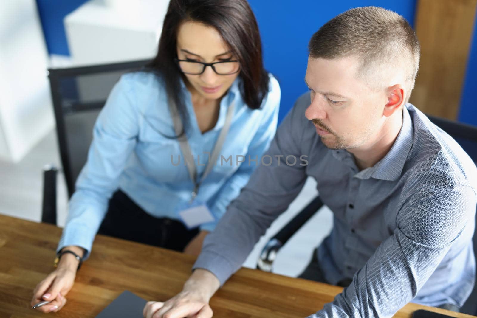 Portrait of coworkers and colleague work on new business project in office. Female employee use laptop, friendly communication in team. Office life concept