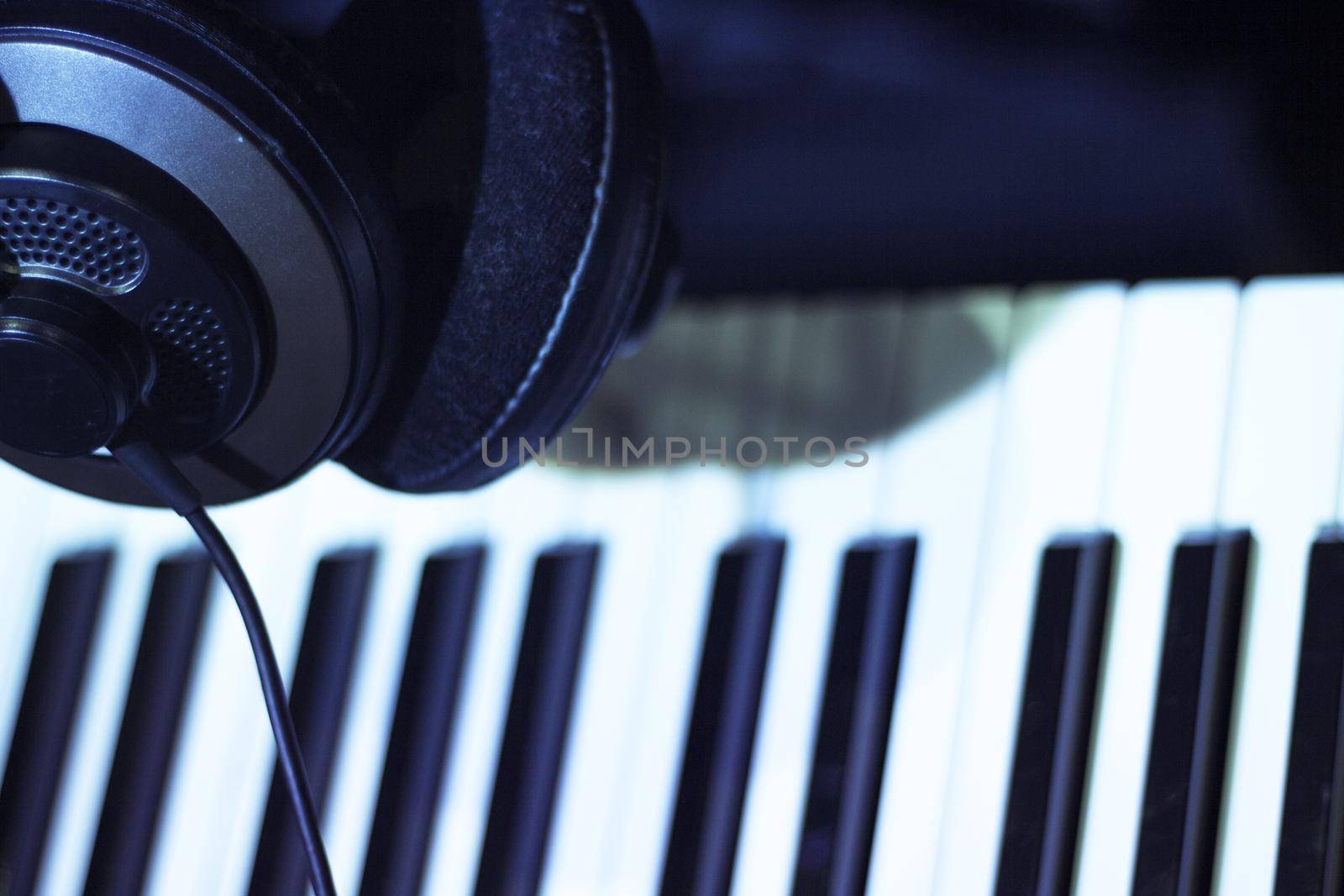 Music headphones on piano keys. No people