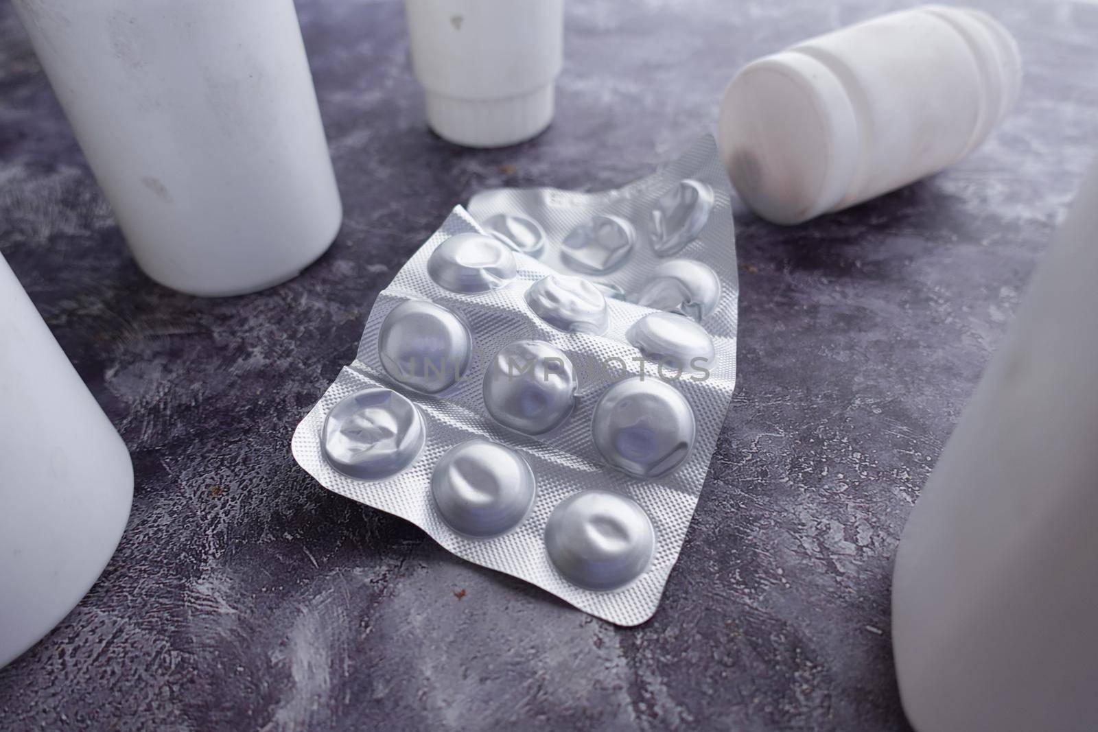 Close up of pills of blister pack on table .