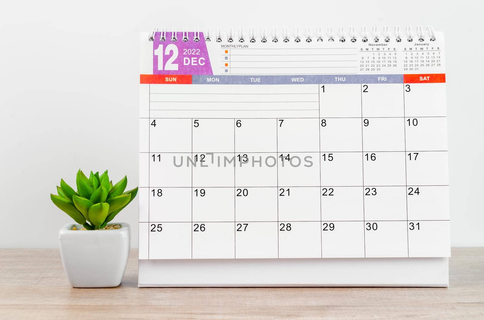 The December 2022 desk calendar on wooden table.