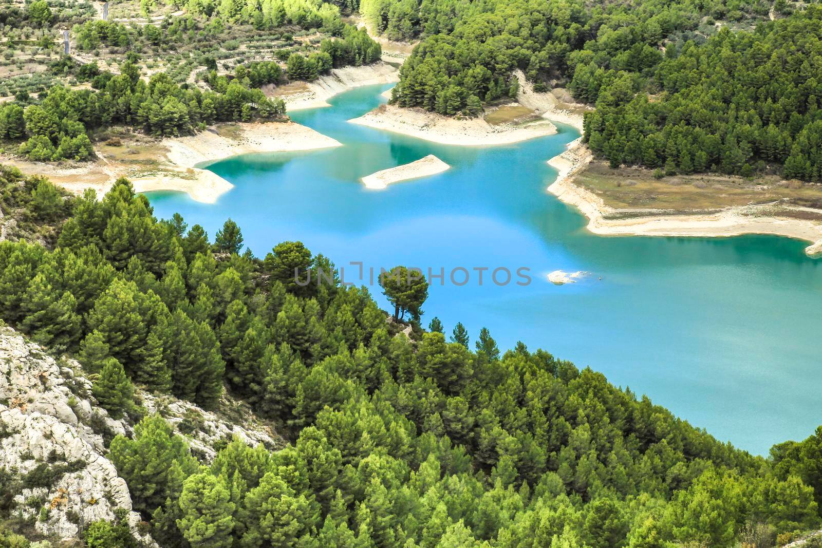 The swamp of Guadalest village surrounded by vegetation and mountains on a sunny day