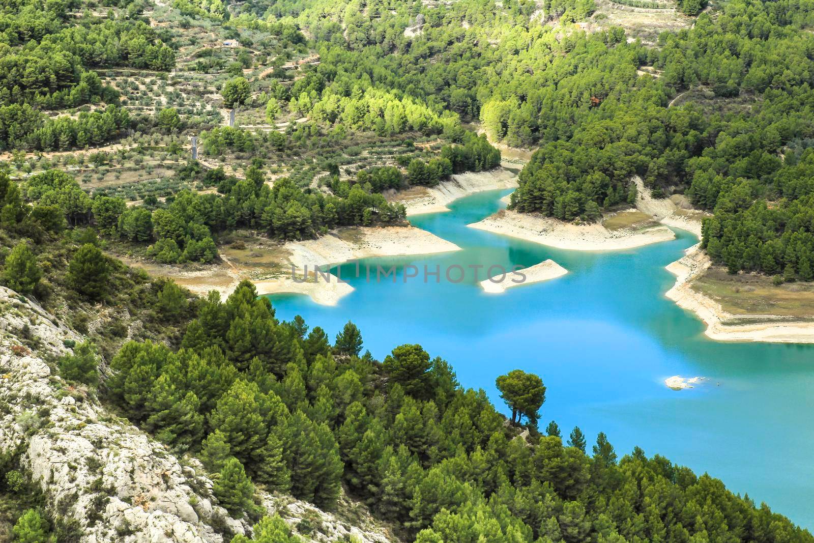 The swamp of Guadalest village surrounded by vegetation and mountains on a sunny day