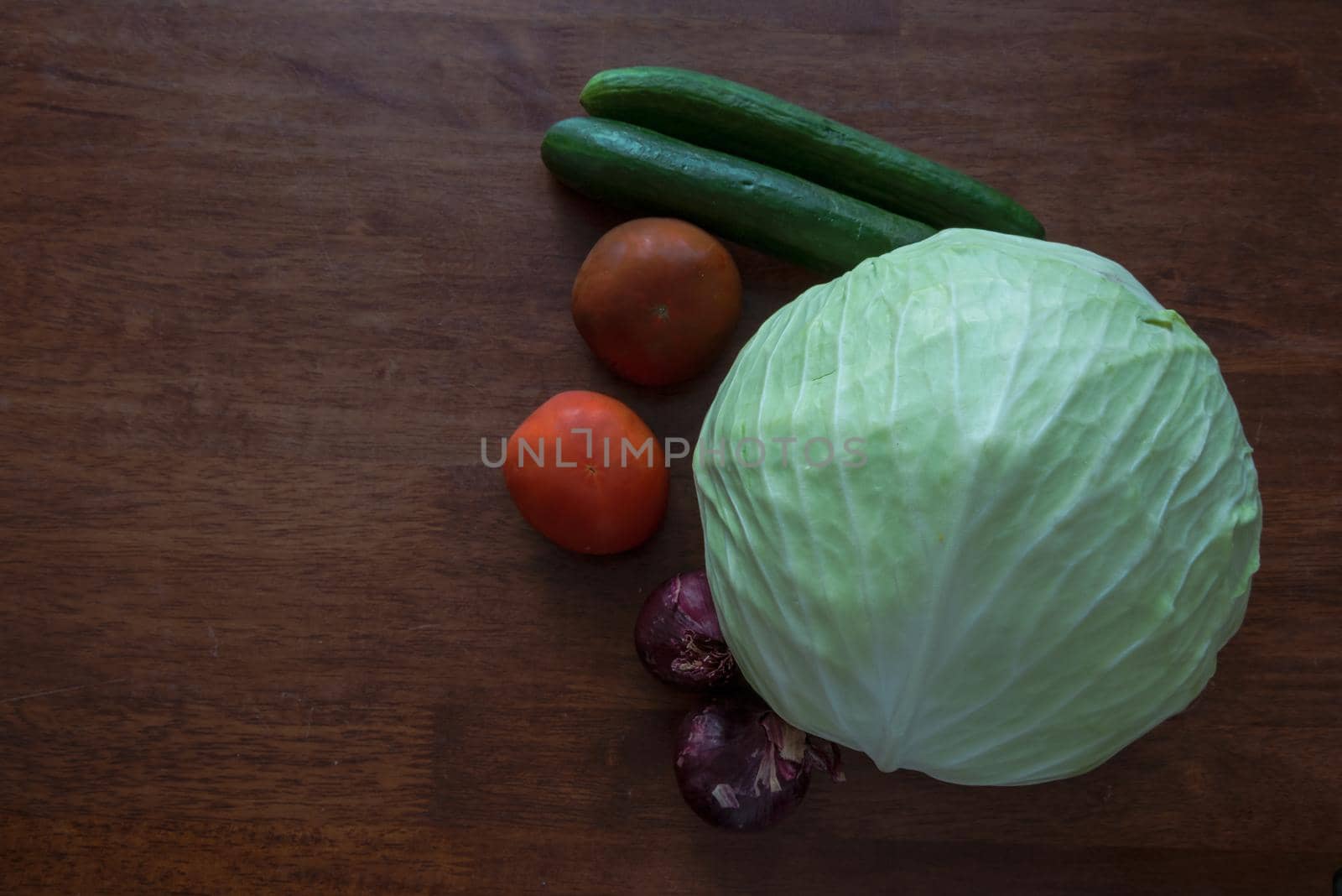 vegetables on the table. cabbage red onion cucumber tomato. A simple appetizer, healthy and vegetarian food. Vintage tone.