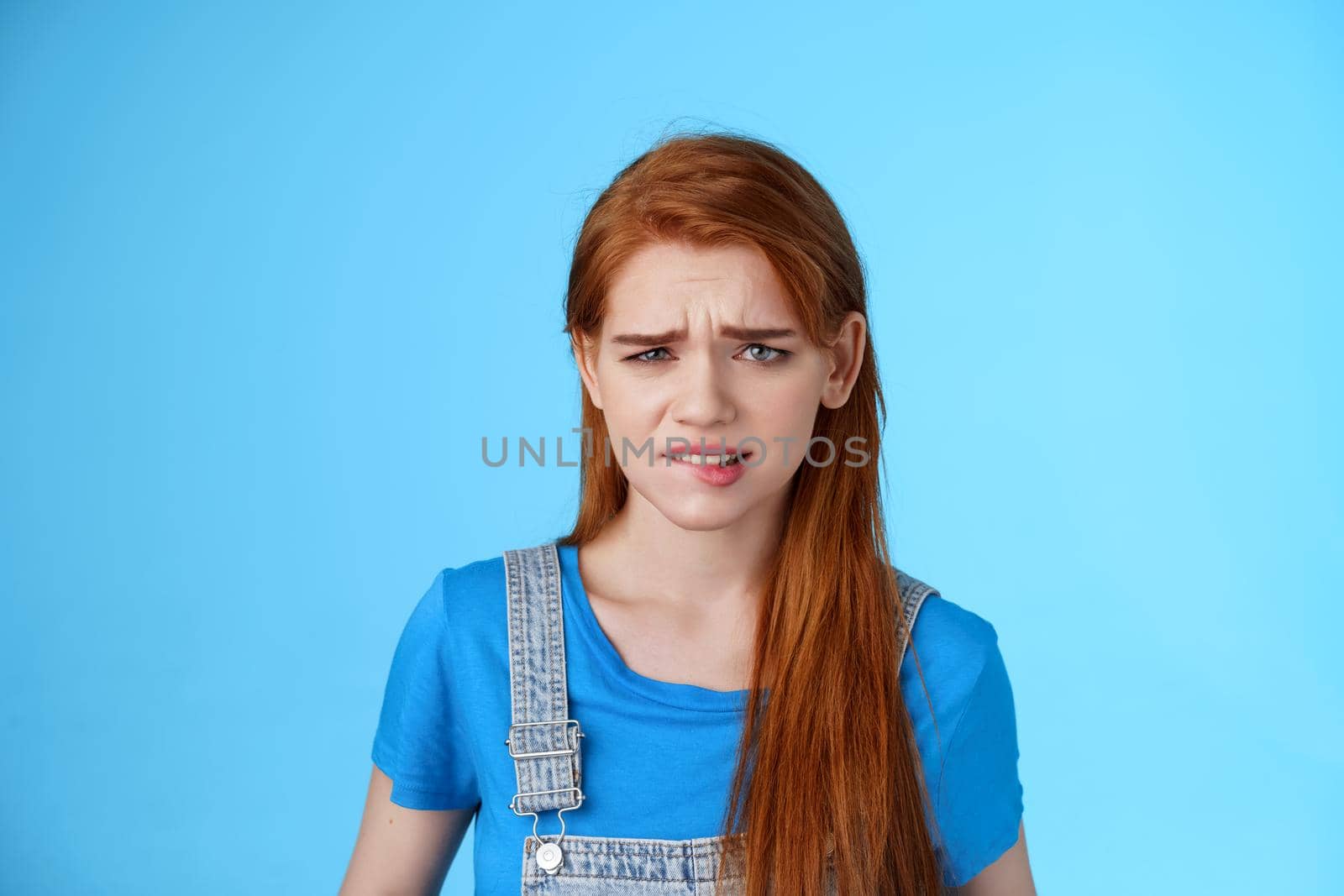 Uneasy upset redhead girl feel uncomfortable, stare frustrated, biting lip frowning, pull sad face upset, apologizing friend, express pity dilsike, stare doubtful uncertain, make bad choice by Benzoix