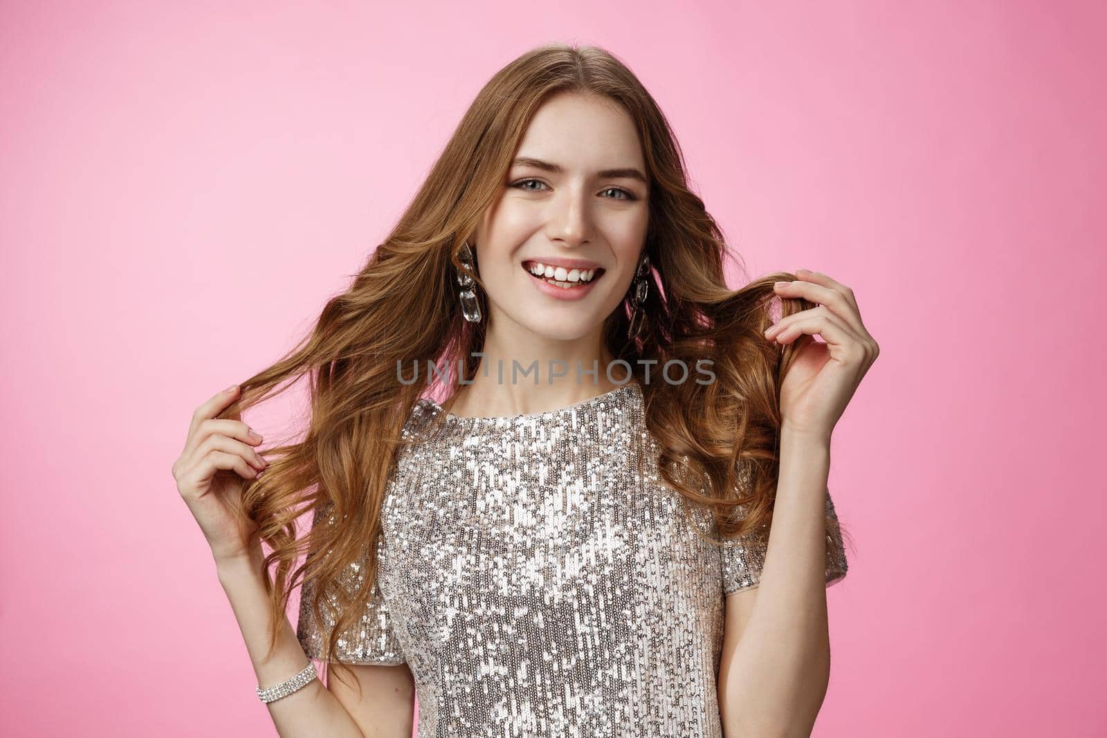 Attractive stylish confident european woman playing curly hairstyle get dressed rock party wearing glittering shiny blouse smiling broadly happily, self-assured she queen, standing pink background by Benzoix