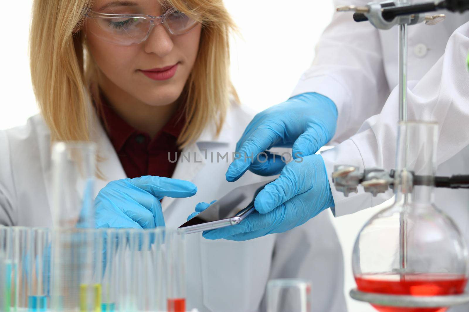 Scientist in chemical laboratory holds smartphone with a display in hand. Mobile applications for scientists concept