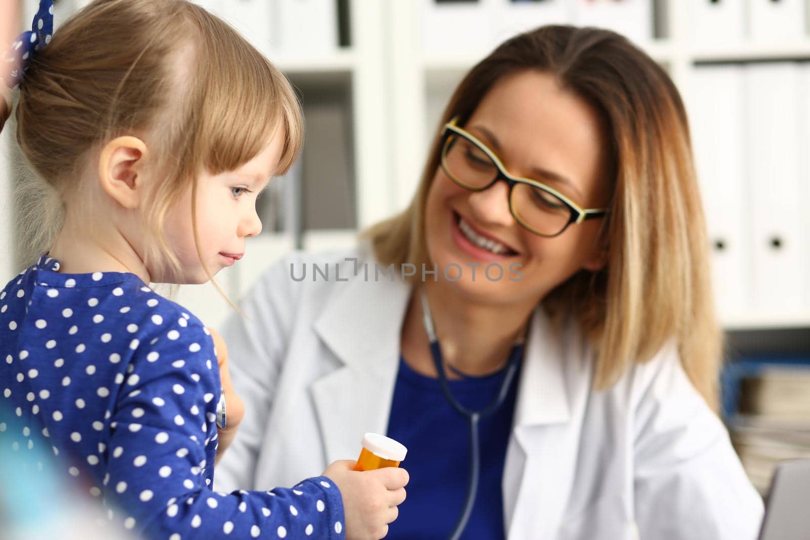 Little child girl at pediatrician appointment closeup by kuprevich