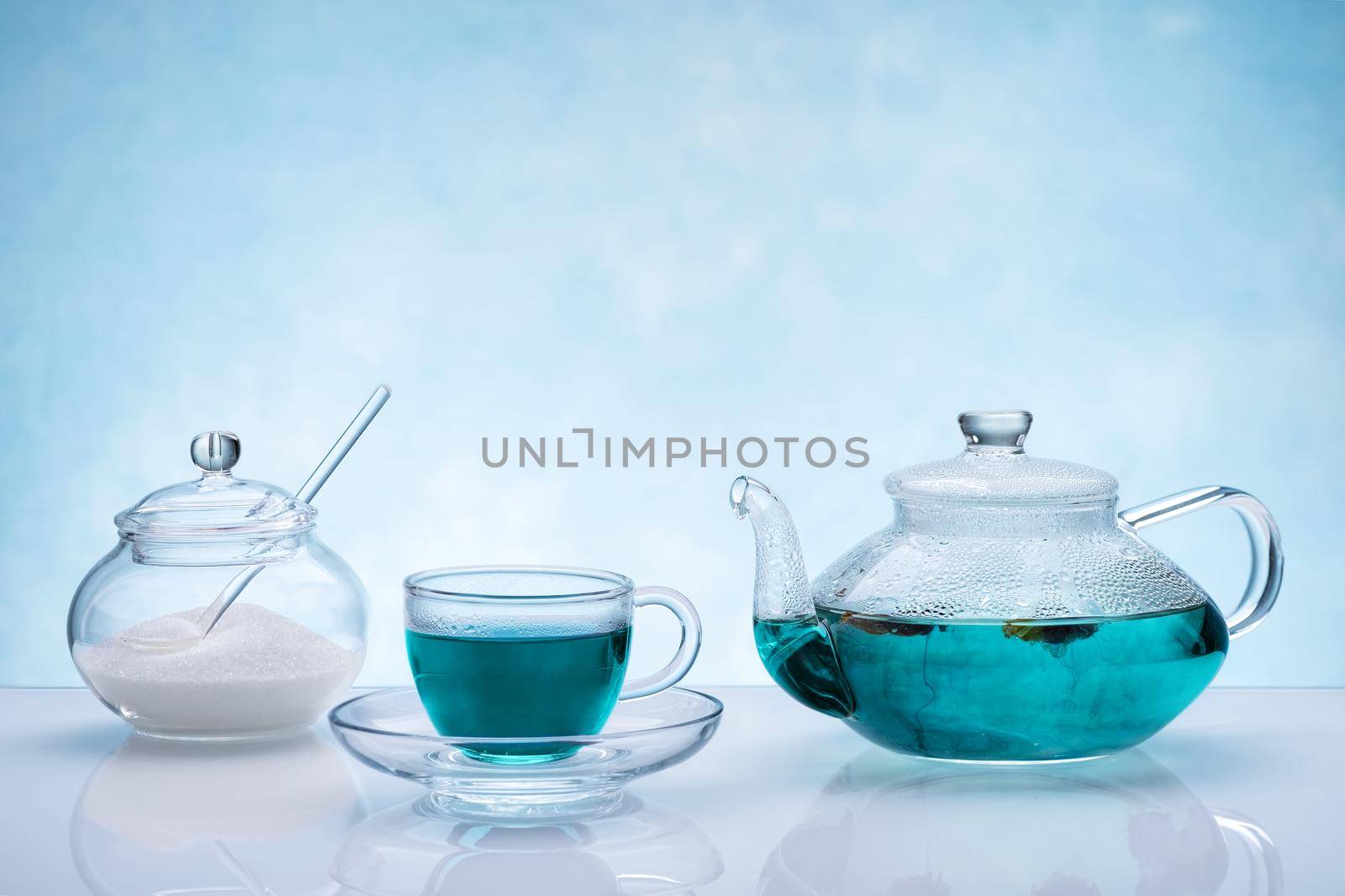 Healthy drinks, organic blue butterfly pea flower tea on blue background.
