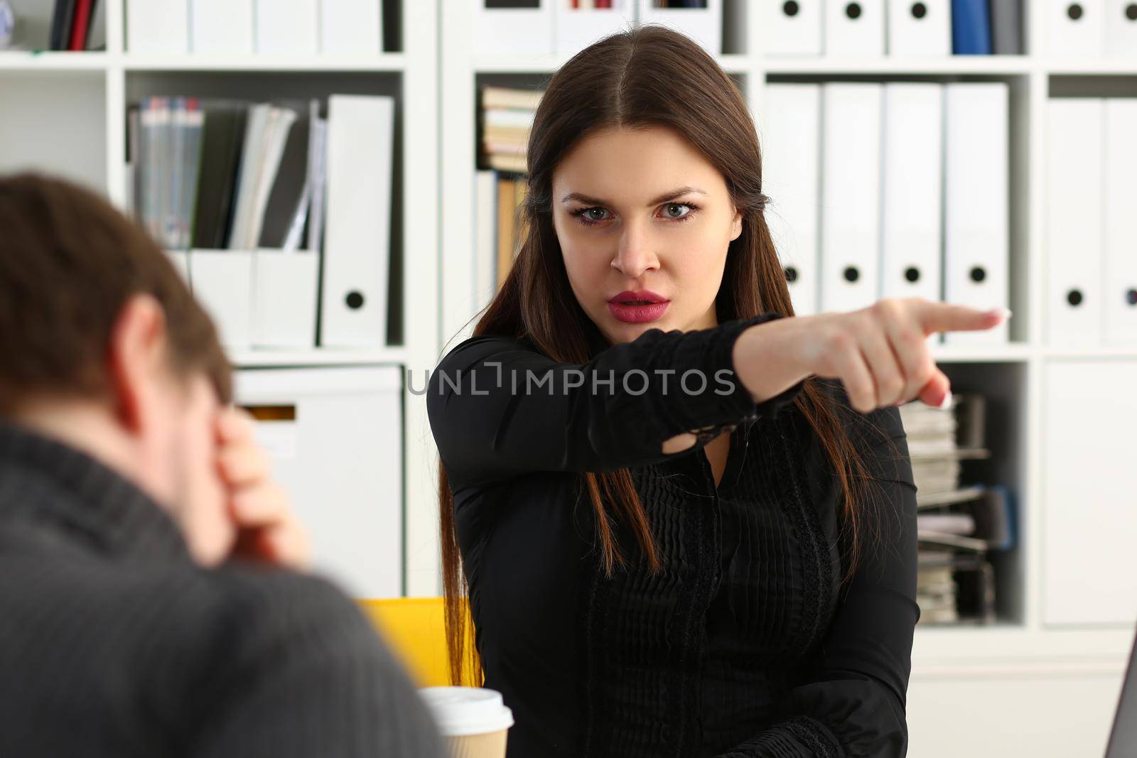 Aggressive female boss points hand to exit, dismissing sad employee. Staff reduction and layoffs concept