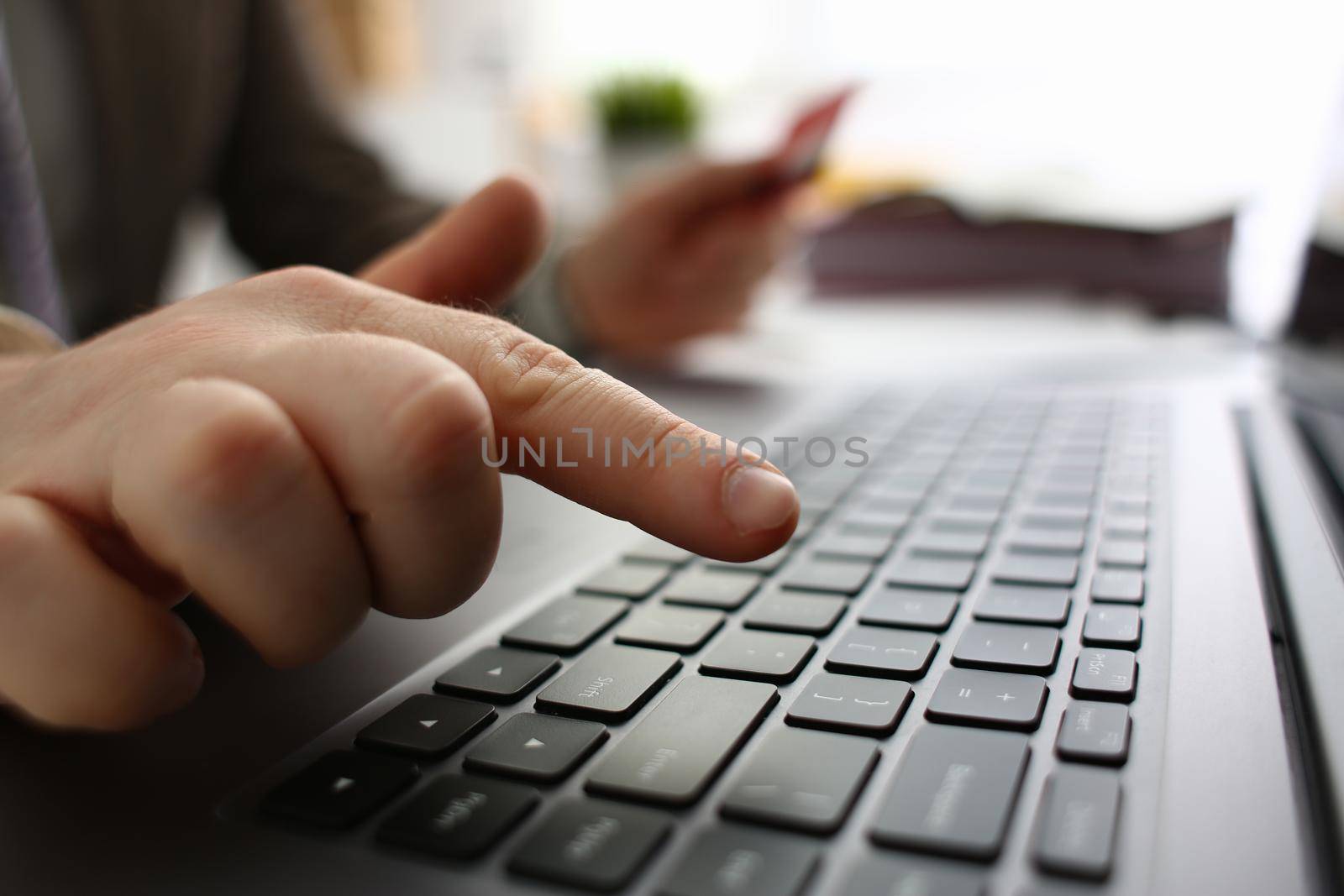 Male hands are holding credit card and typing on keyboard. Financial security and online payments concept