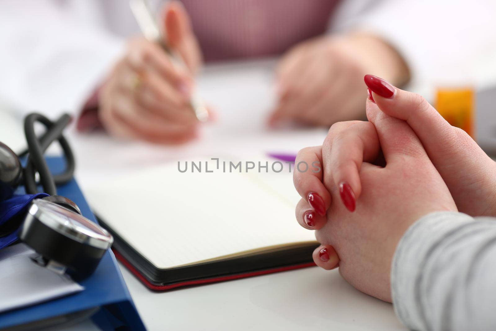 Hands of woman patient for medical report written by doctor about health condition. Medical service concept