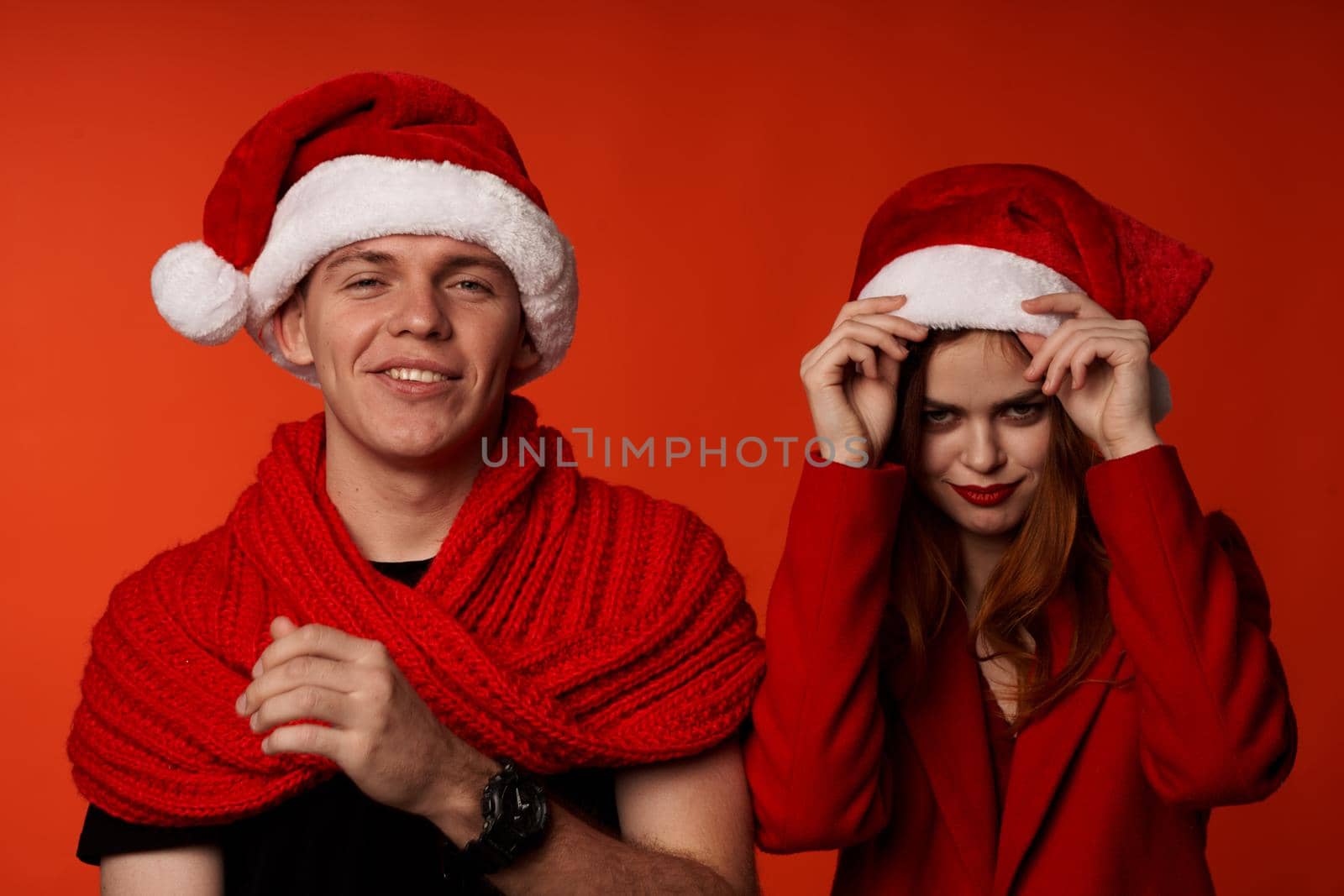 young couple in santa hats fun new year holiday studio Lifestyle by SHOTPRIME