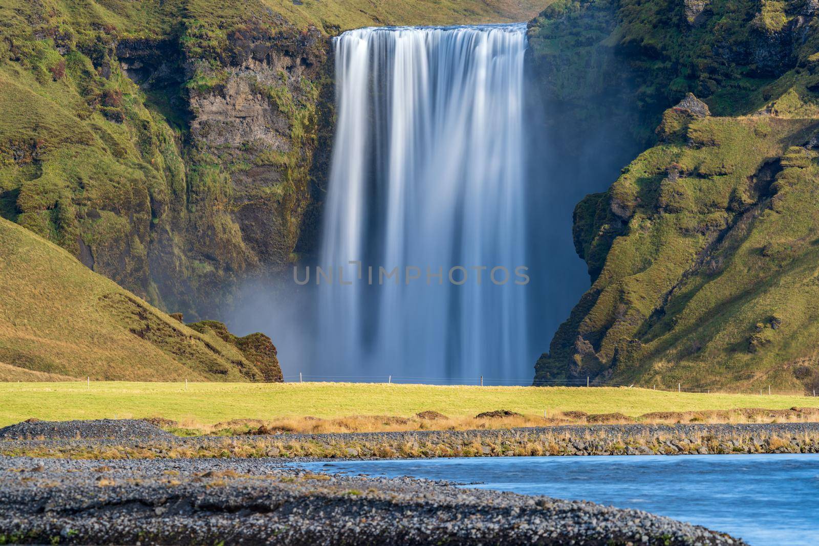 Long exposure of Skogafoss waterfall in Iceland from the distance river by FerradalFCG