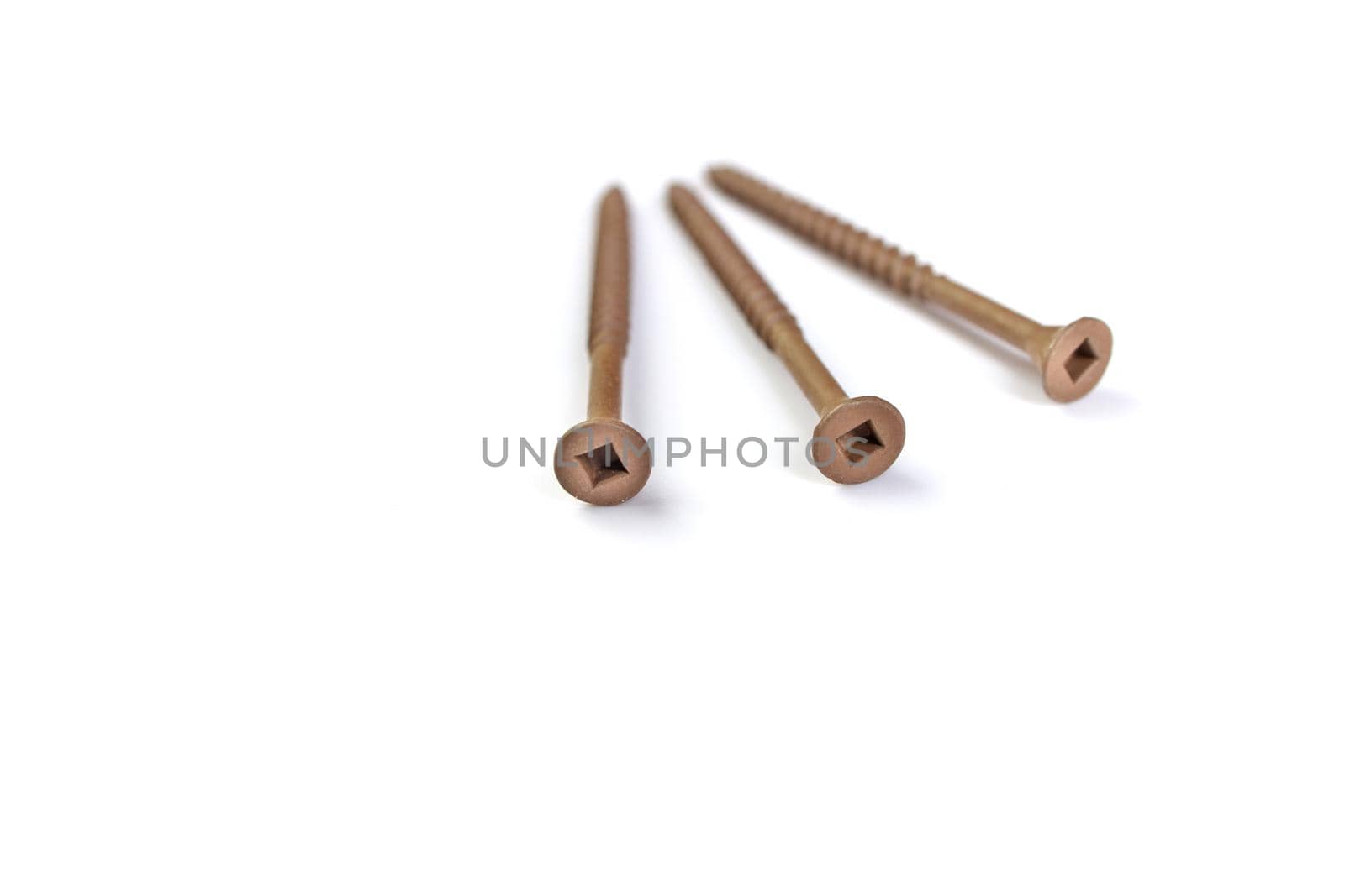 A pile of 3 inch Brown Deck Screws Isolated on a White Background. High quality photo